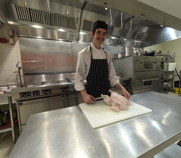 Students at Eastdale CI learn to debone a whole chicken. Open Gallery